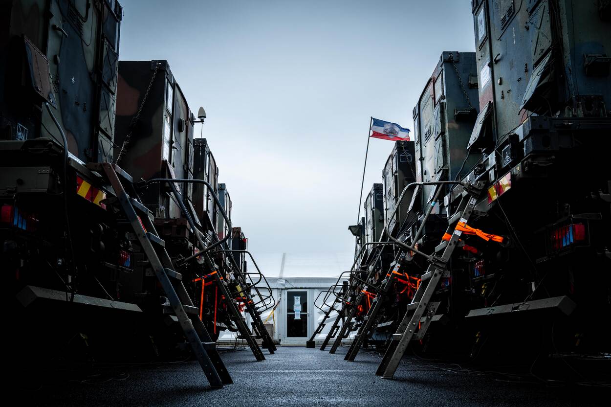twee rijen vrachtwagens met de achterzijden naar elkaar toe geparkeerd.