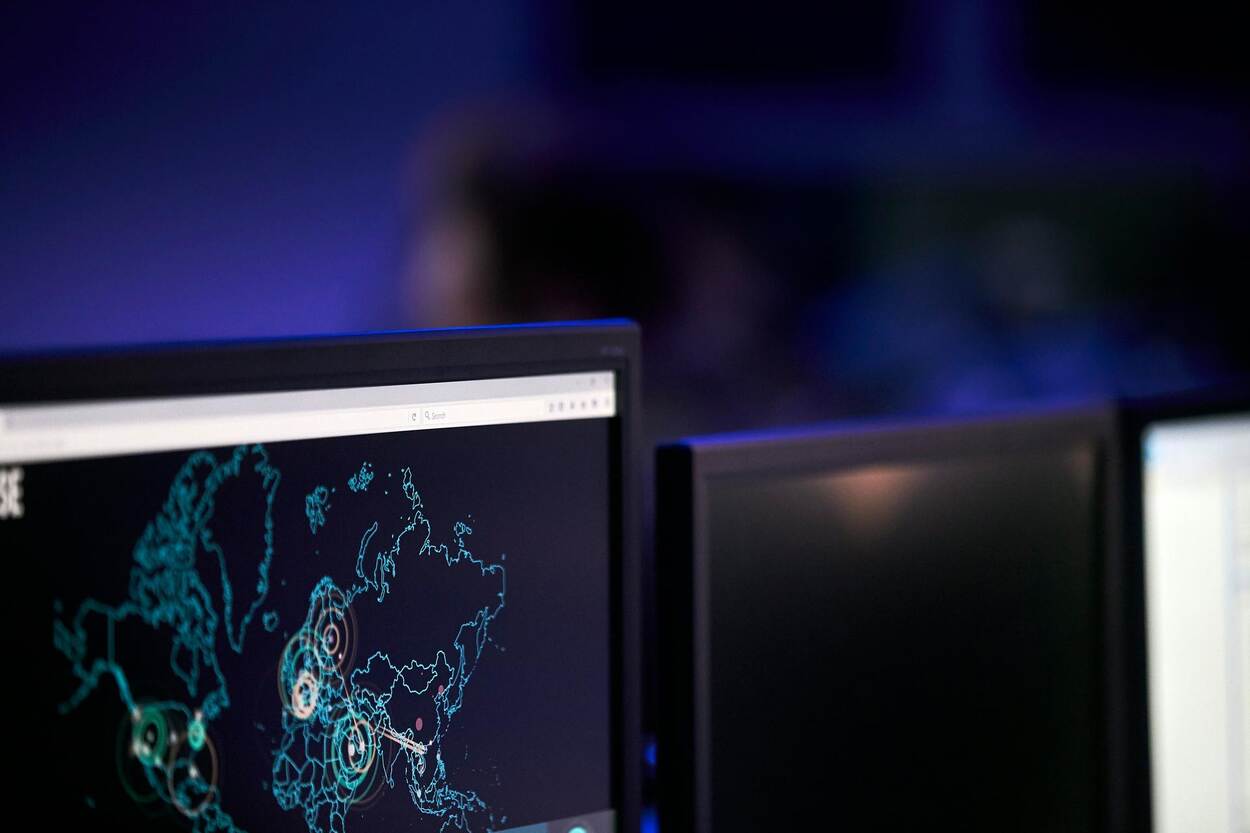 Deel van een computerscherm in een donkere ruimte. Op het scherm is een wereldkaart te zien.