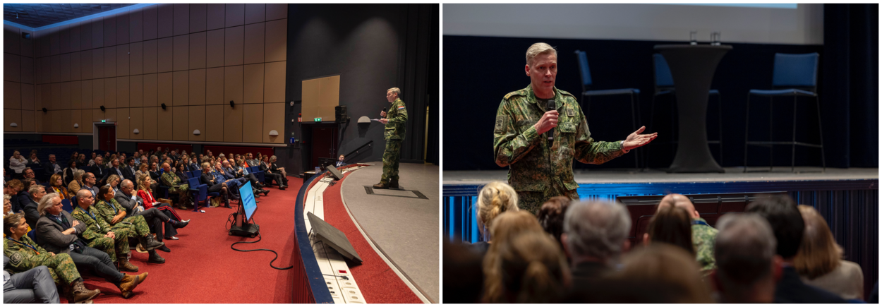 Generaal Maas houdt een microfoon in zijn hand en spreekt de aanwezigen toe.