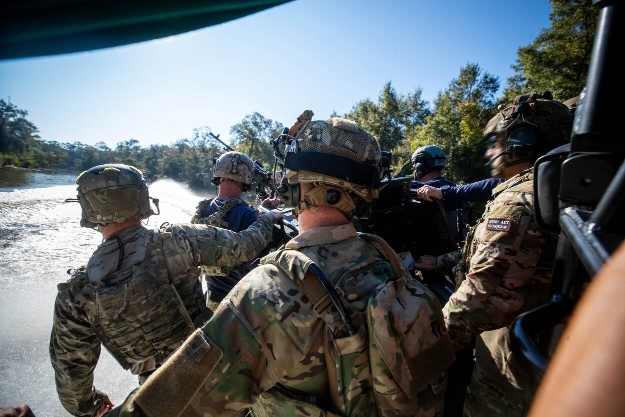 Militairen zitten samen op een snelle boot.