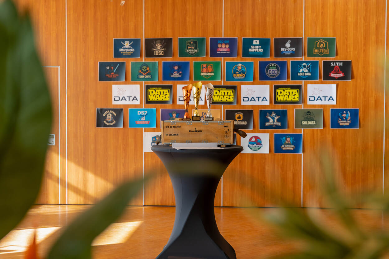 3 bekers op een statafel voor een groot schot met bordjes.