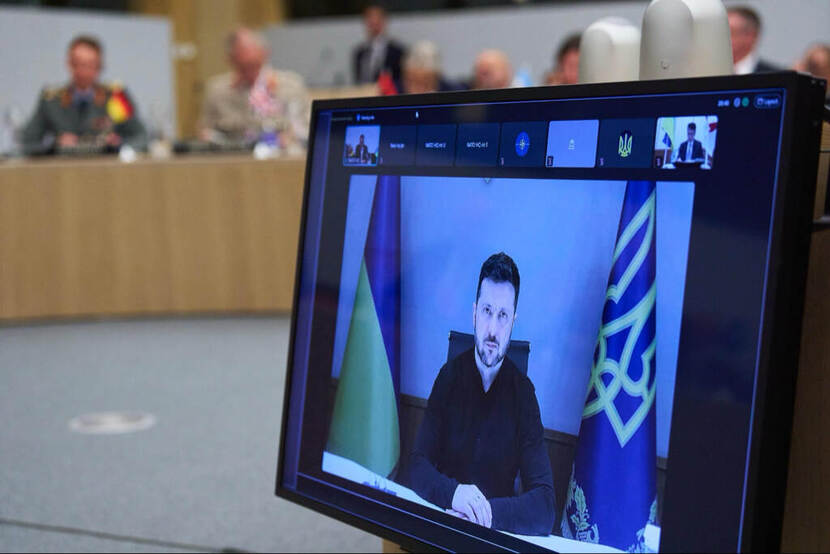 De Oekraïense president Zelensky op een beeldscherm tijdens een overleg