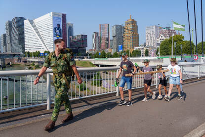Kinderen lopen met een balk over een brug