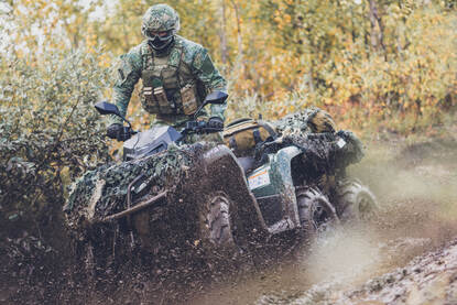 Links gooit een mariniers een drone de lucht in. Rechts rijdt een marinier op een quad met 6 wielen.