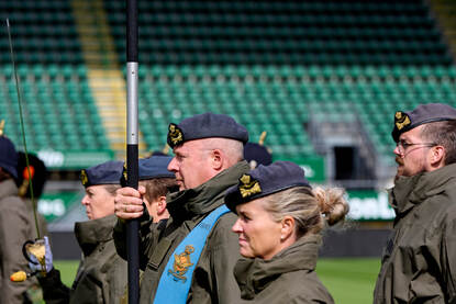 Vaandeldrager adjudant Peter de Kruit vanaf de zijkant. In zijn handen heeft hij het vaandel.