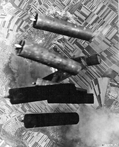 Acht Monroe-bommen vallen uit een vliegtuig richting een stad.