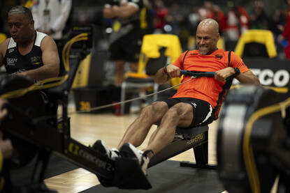 Renaldo Ishaak aan het werk op een roeimachine op het onderdeel indoorroeien.